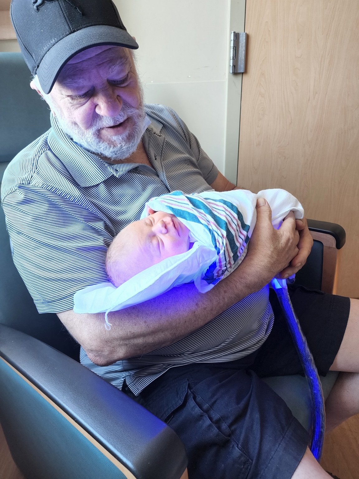 Warren M. Barich holding his newborn grandson